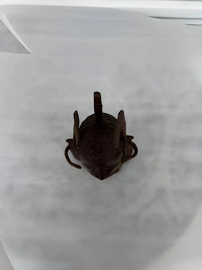 Brass Benin artwork featuring ancestral head sculpture