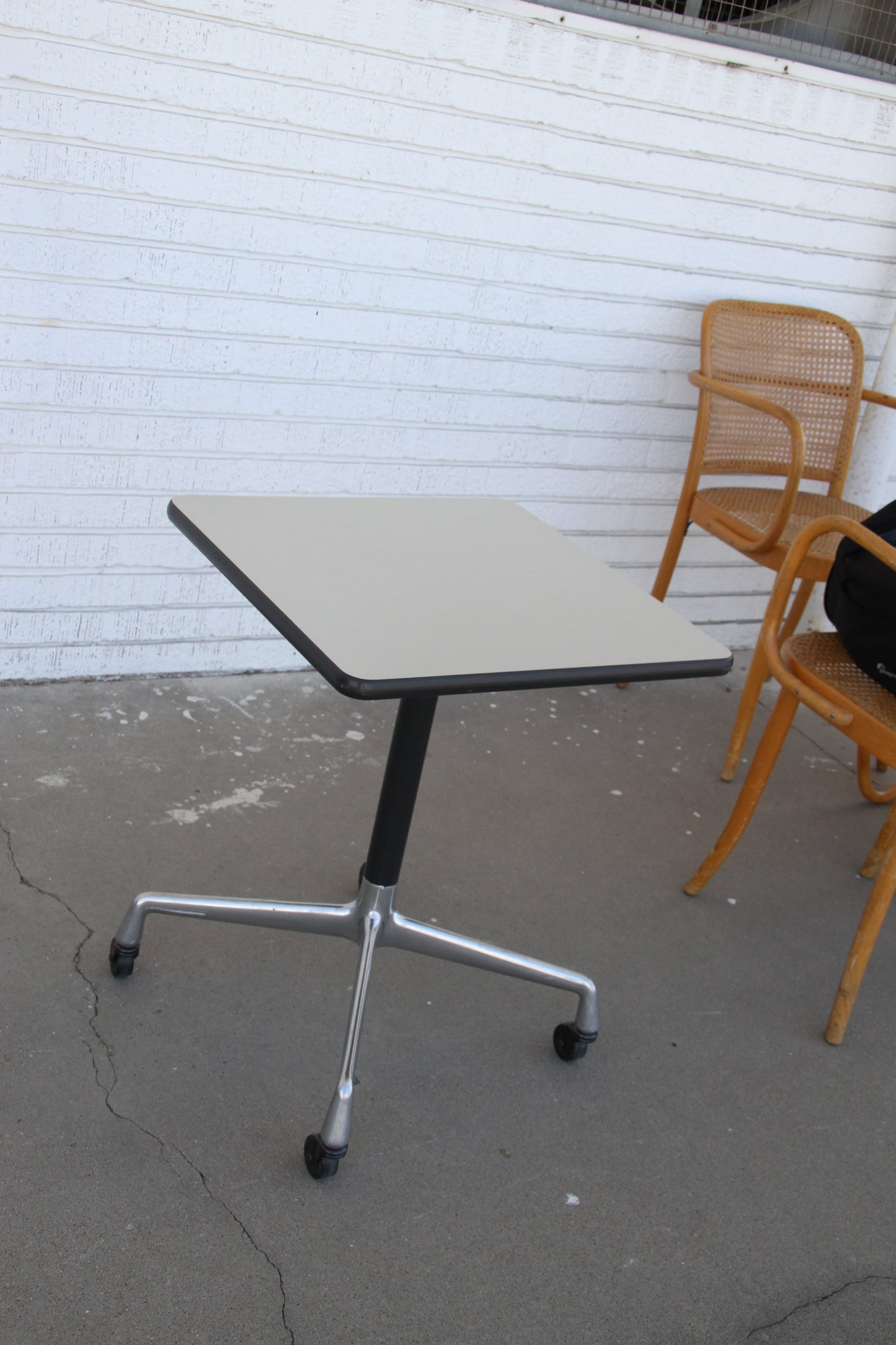 Eames square office table with rolling base