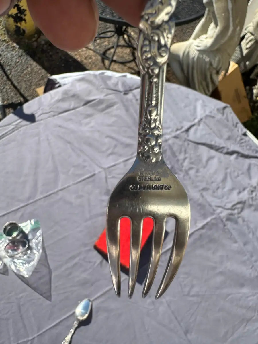 sterling silver fork with intricate handle pattern