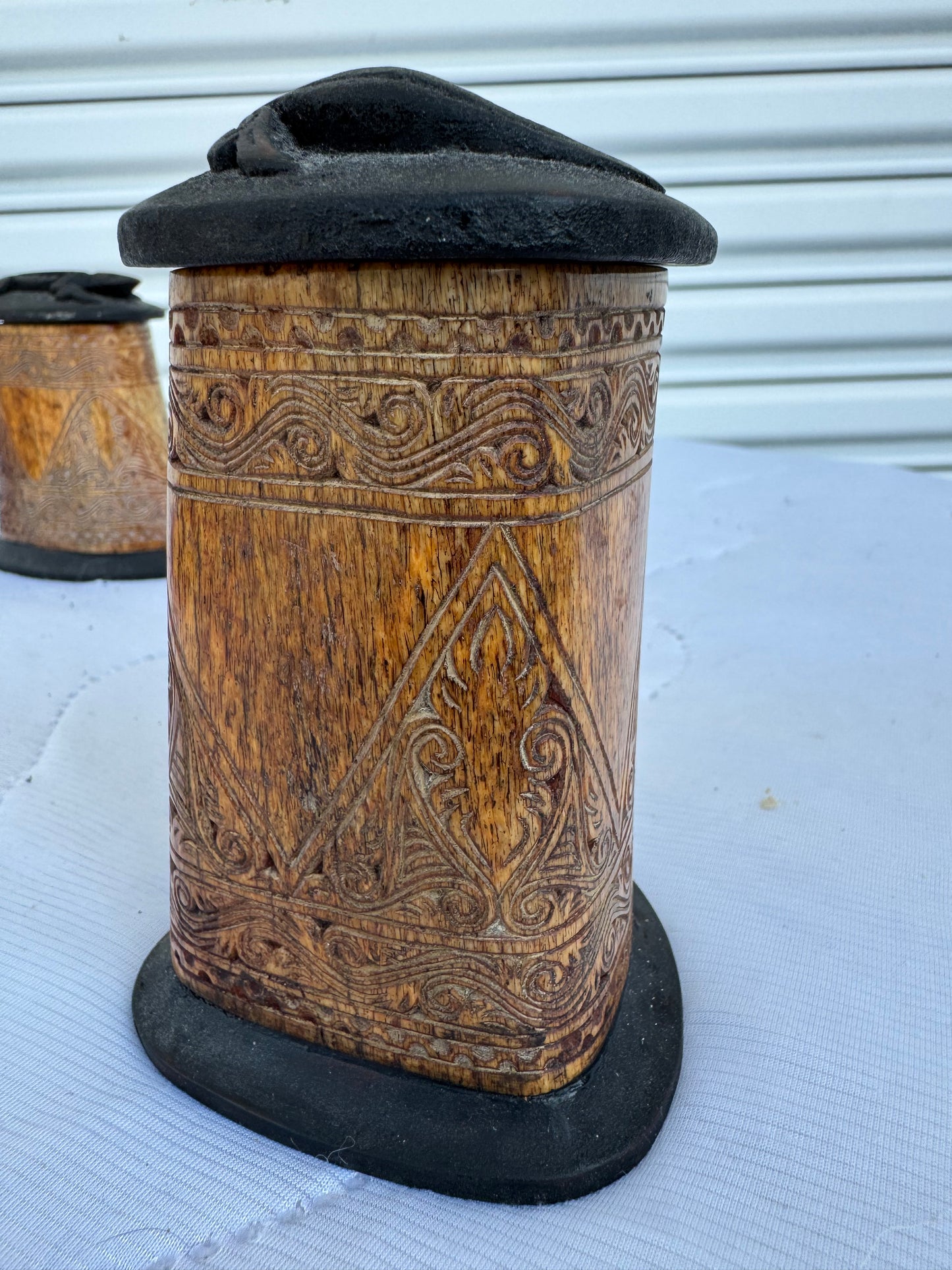 Traditional bone containers with engraved geometric and swirling motifs