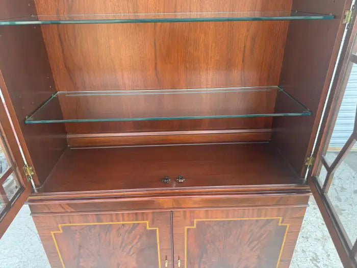 Antique-style breakfront china cabinet with detailed woodwork