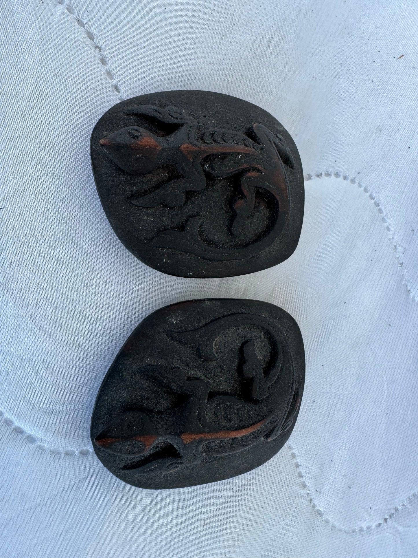 Close-up of tribal swirling designs on carved bone container