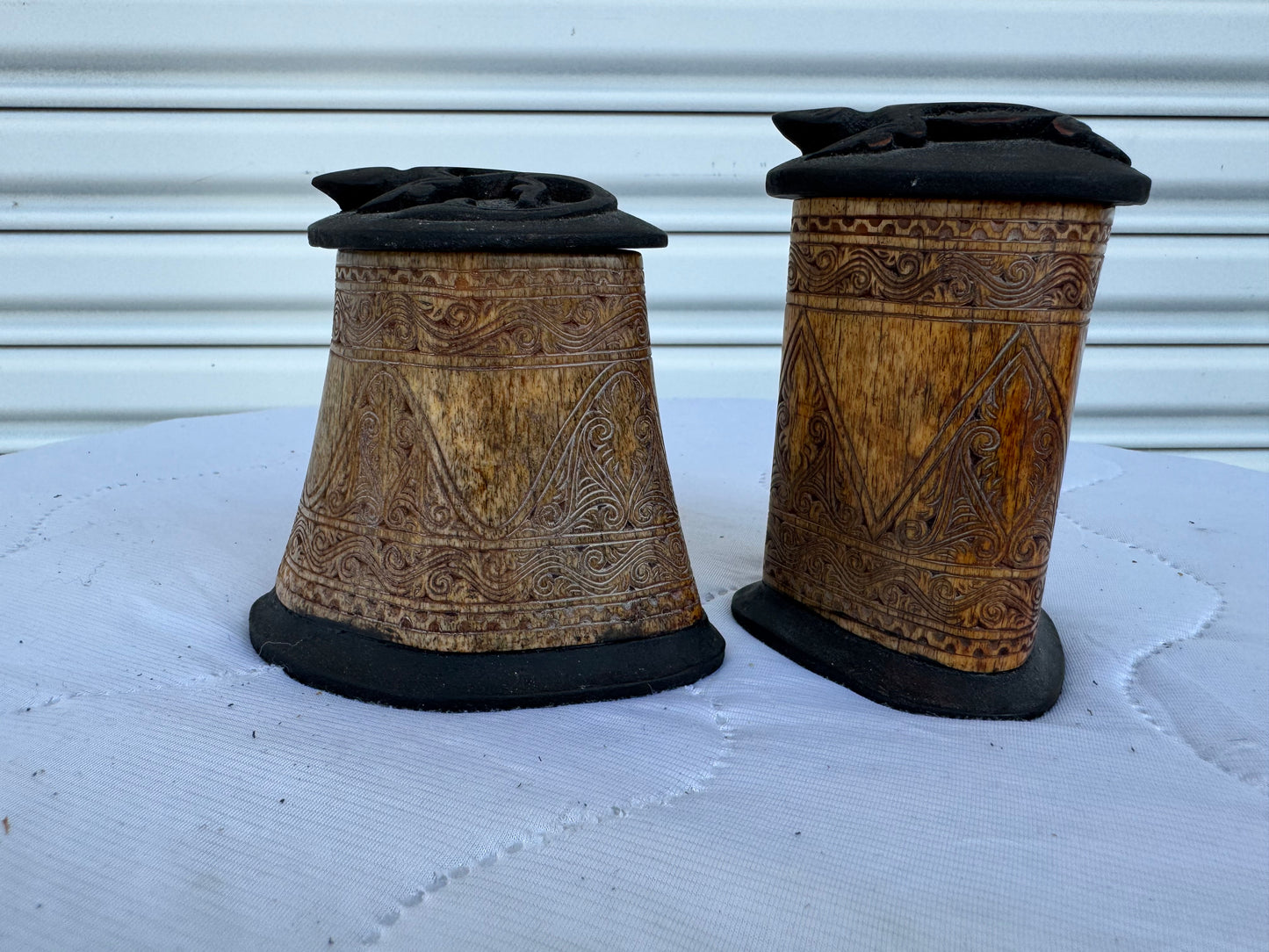 Intricate hand-carved bone container with ornate tribal art and lid