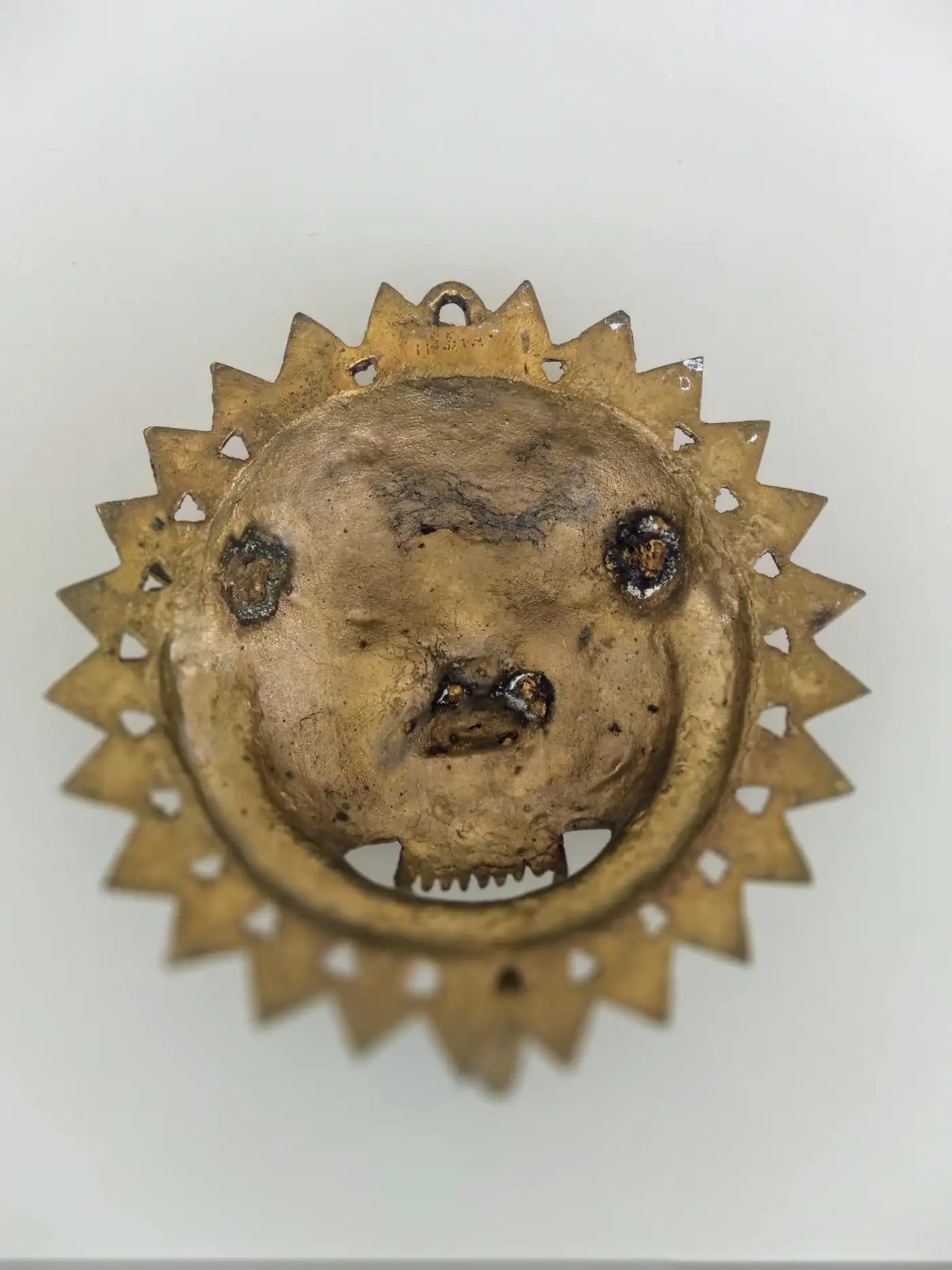 Artisan-crafted brass mask from India with bejeweled design