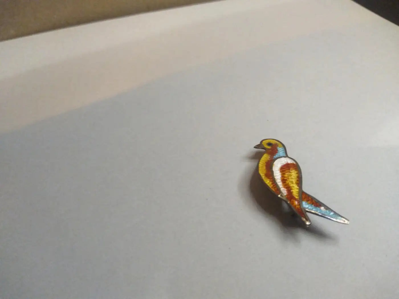 Enameled sterling silver parrot brooch