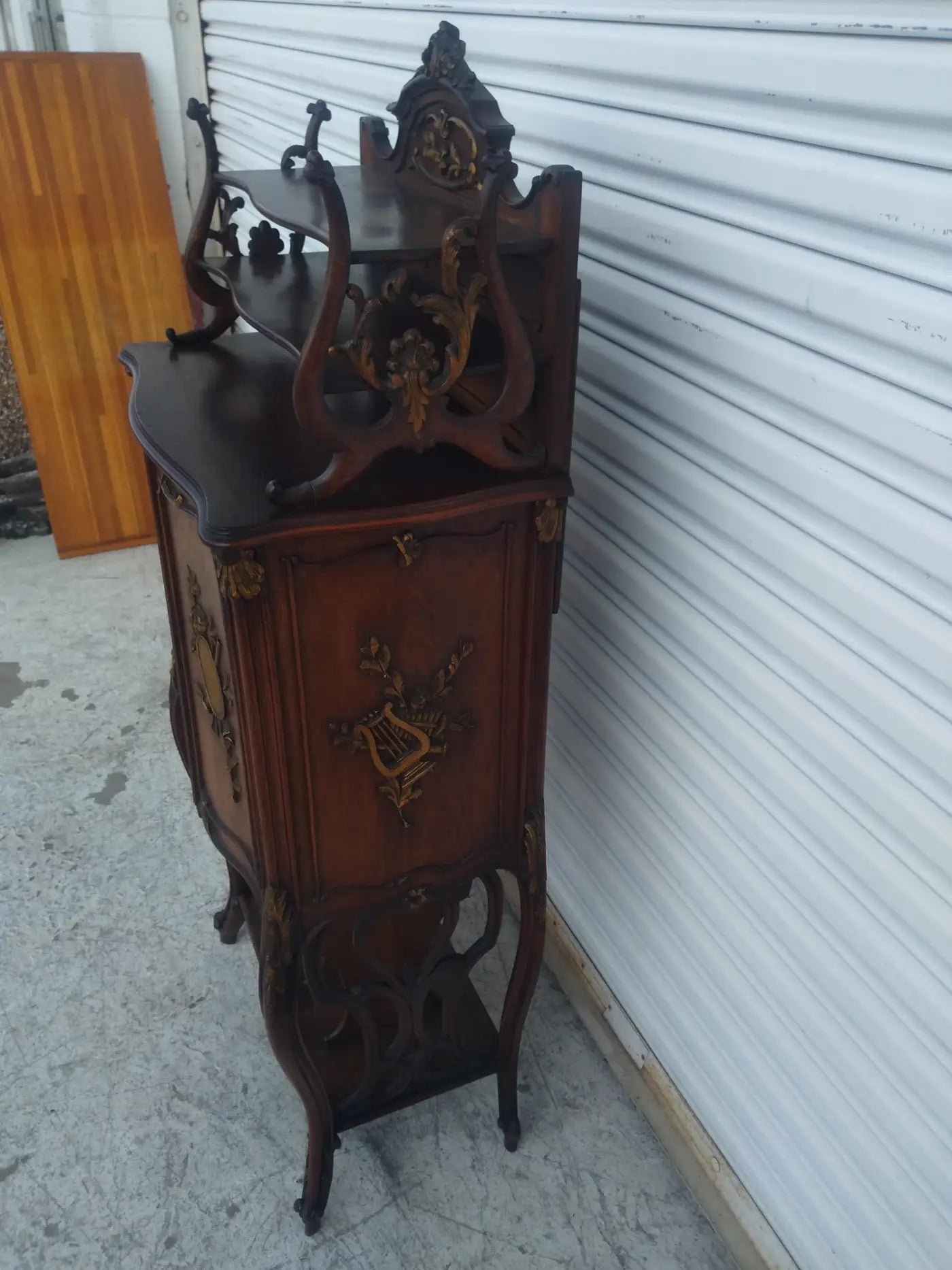 Gilded antique cabinet for music storage