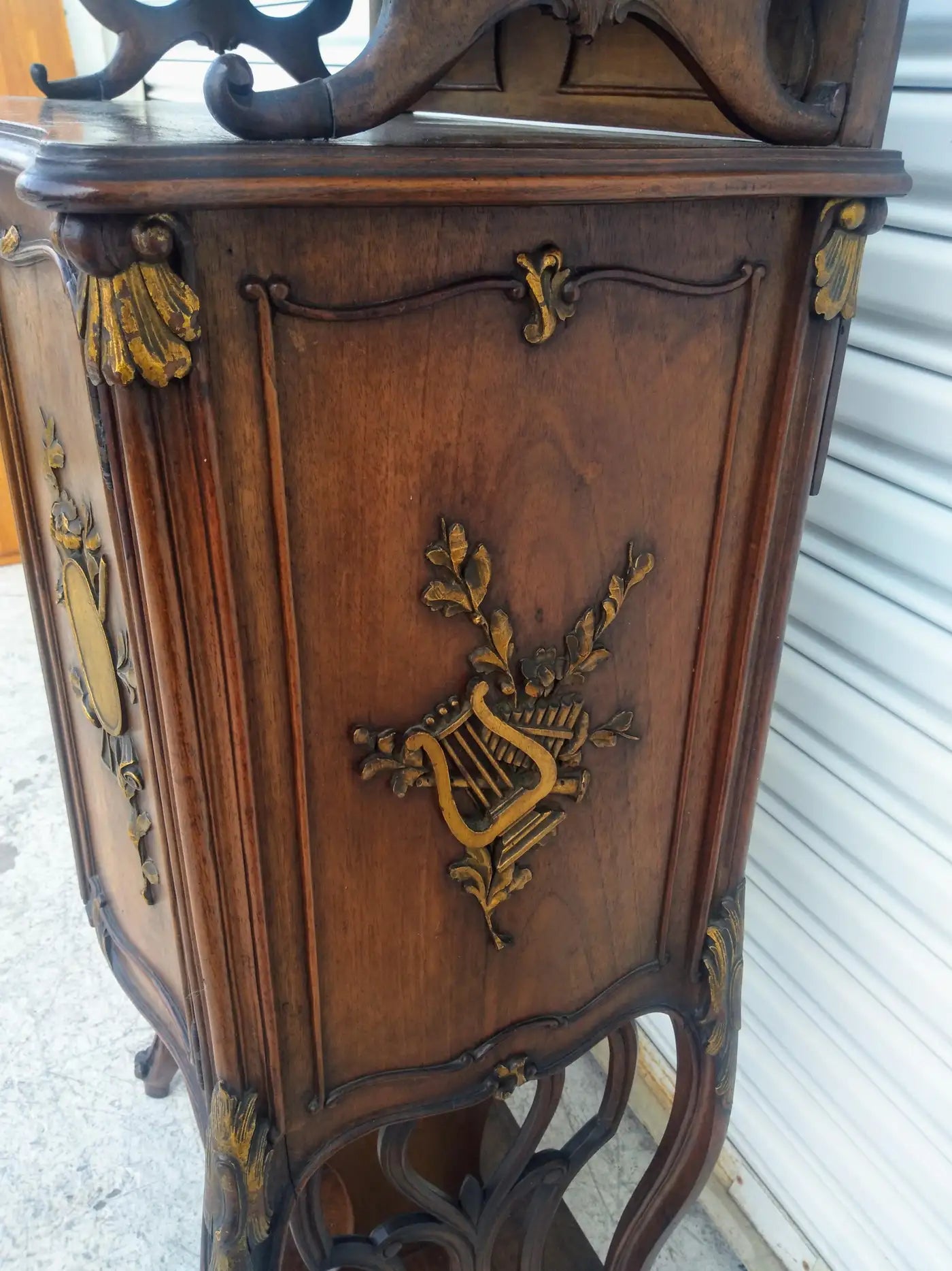 Hand-carved French walnut cabinet with gold trim