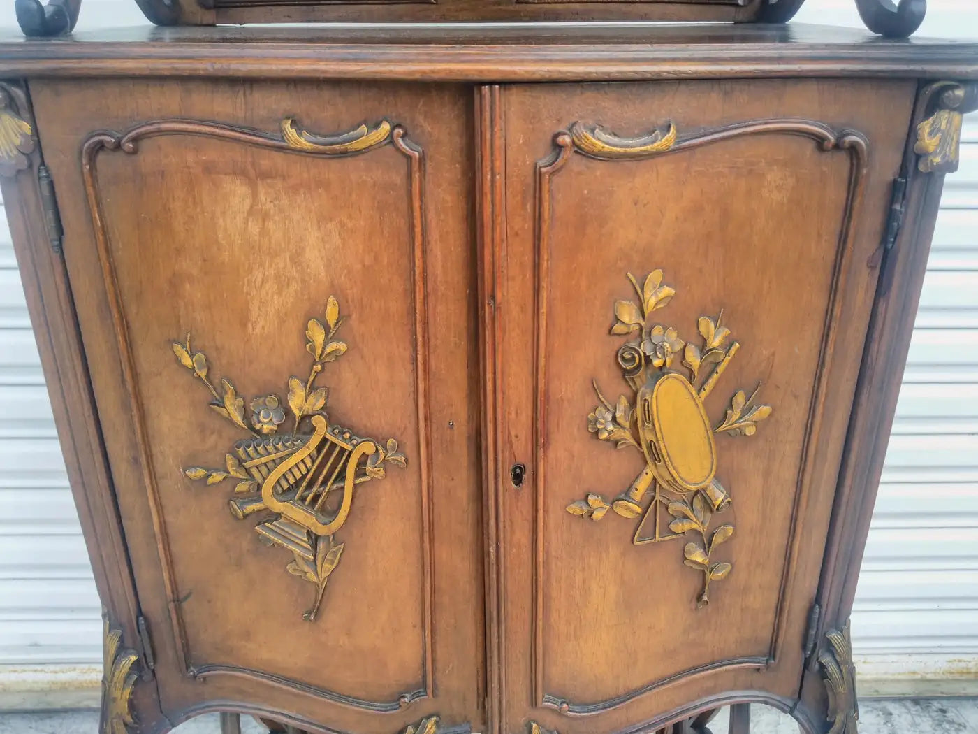 Vintage walnut cabinet with gilt accent decor