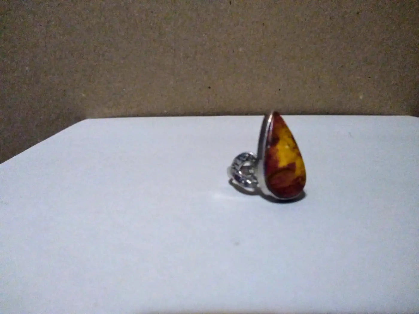 Sterling silver ring featuring flaming amber