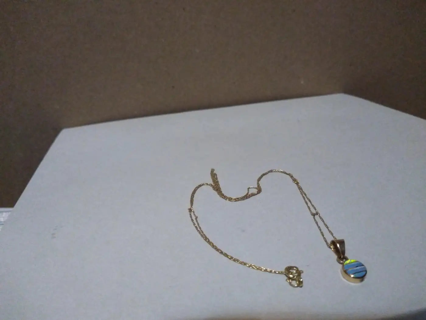 Close-up of gold opal trace necklace