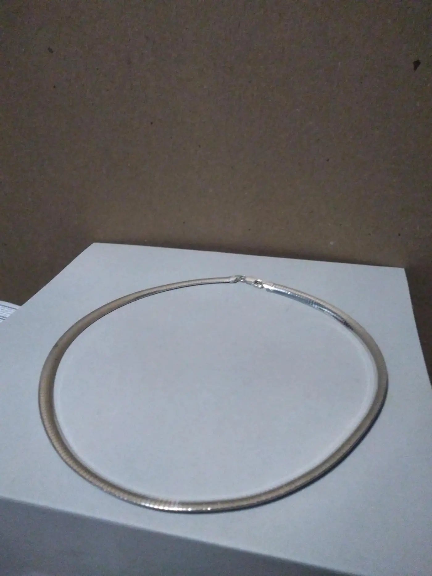 Wide sterling silver omega chain on display