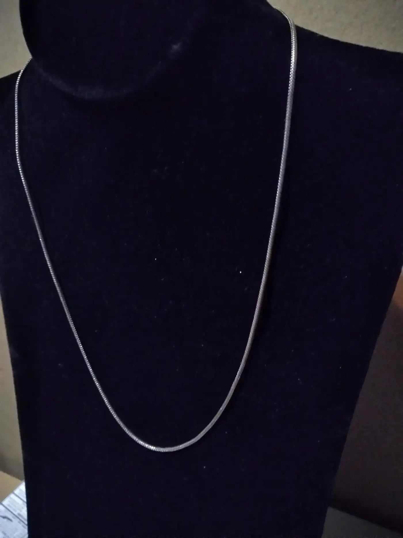 Shiny sterling silver chain on white background