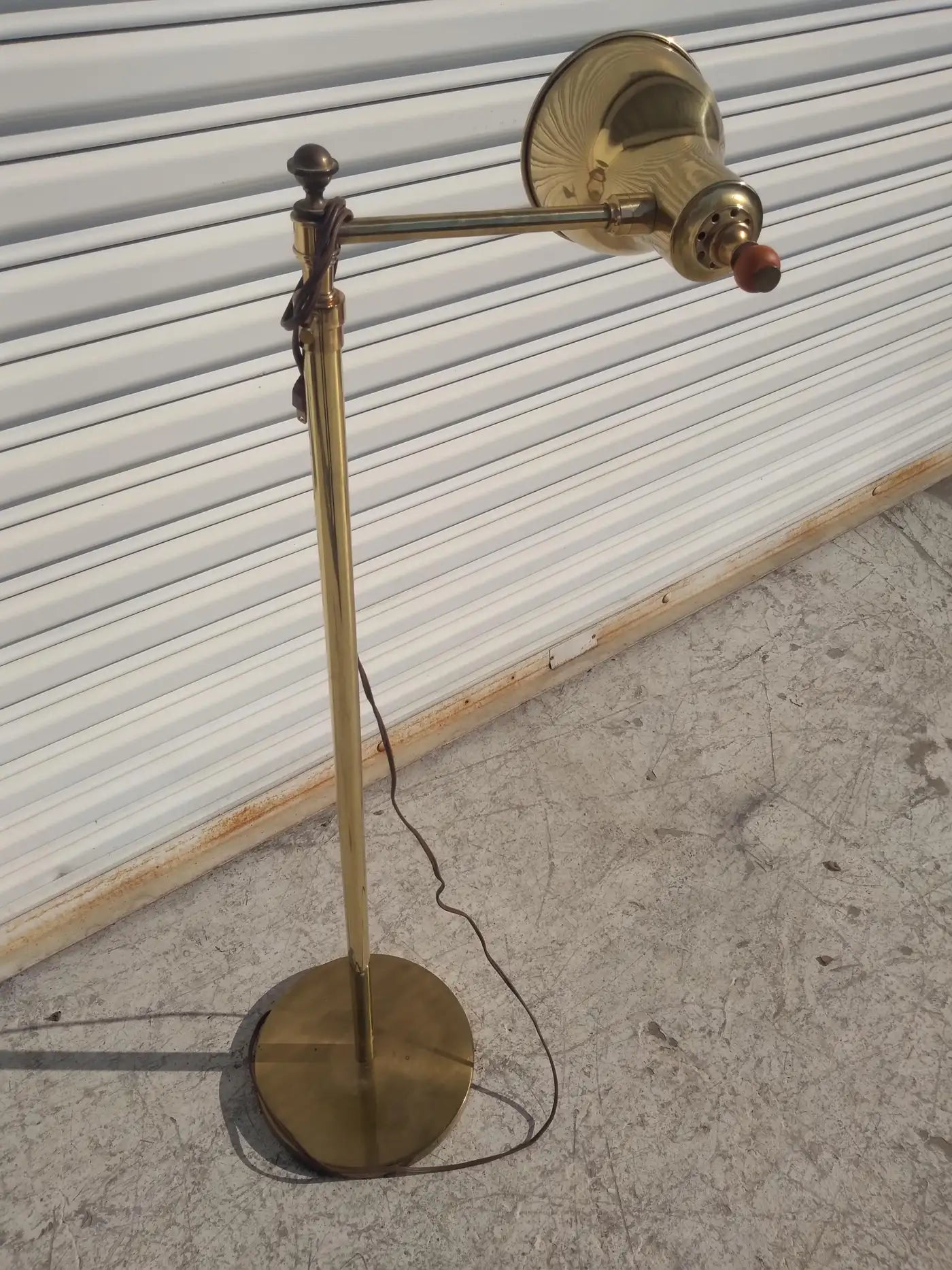 Brass floor lamp with swivel feature and tall base