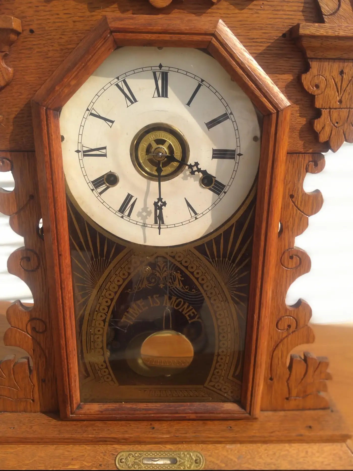 Vintage gingerbread mantle clock in walnut wood