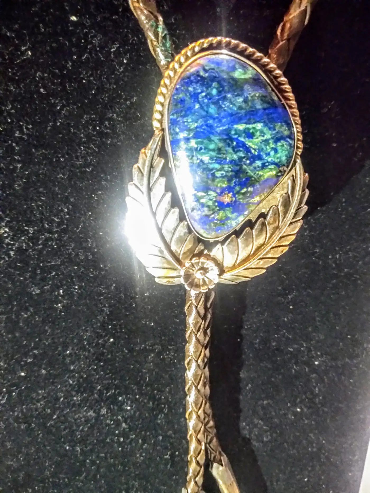 Leather and sterling silver bolo tie featuring blue opal medalli