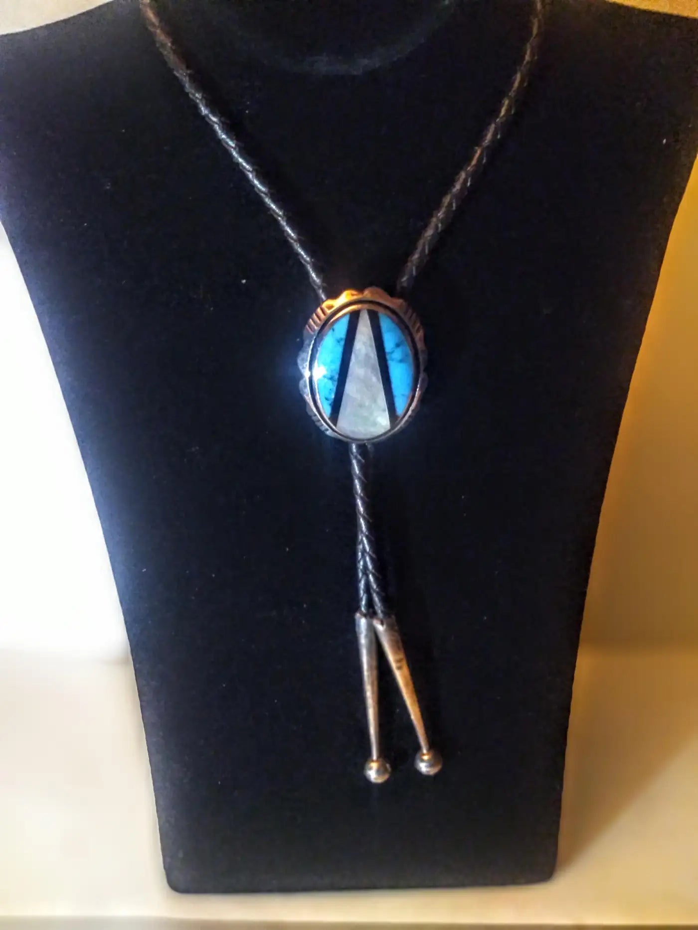 Handcrafted Native American bolo tie with leather cord