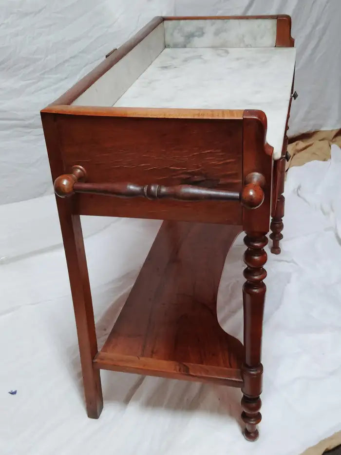 Victorian marble washstand console with intricate wood carvings