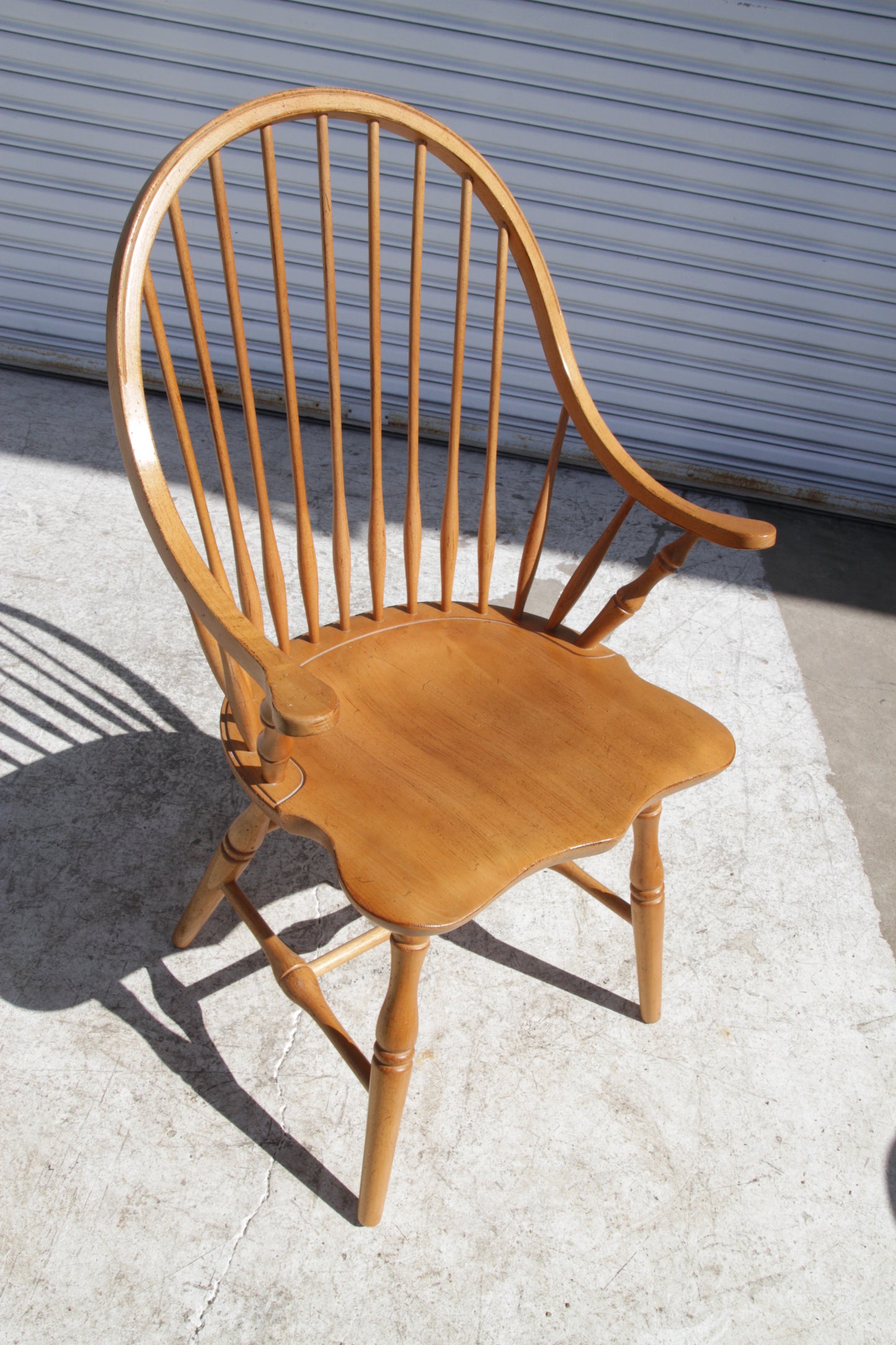 Classic Windsor chair in maple wood with arms, great as a dining chair or accent piece