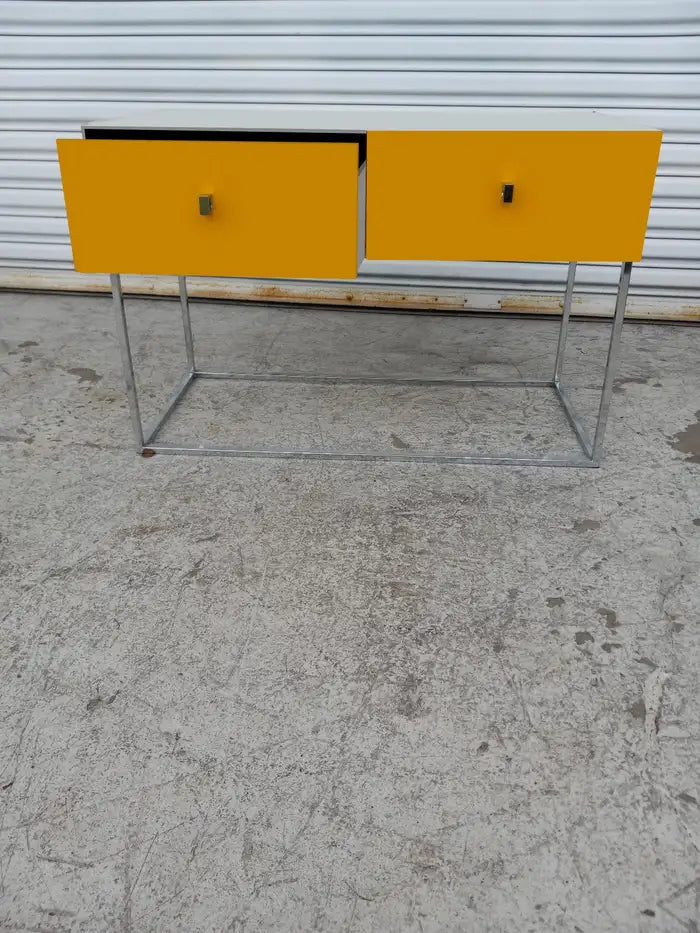 Minimalist modern desk with chrome base and two functional drawers.