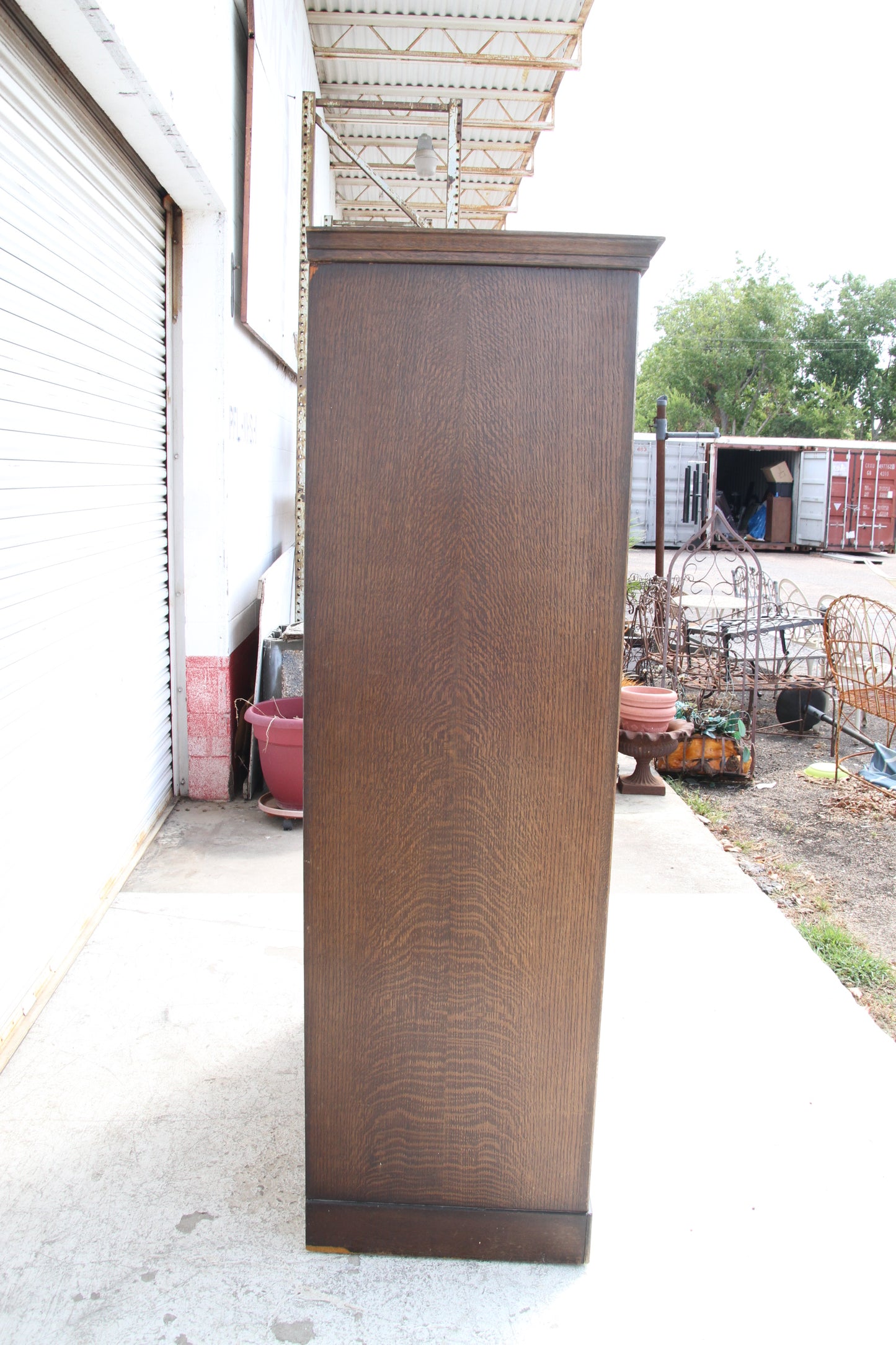 Bring a piece of history into your home with this vintage imported London wardrobe armoire. This antique storage cabinet is a true statement piece.