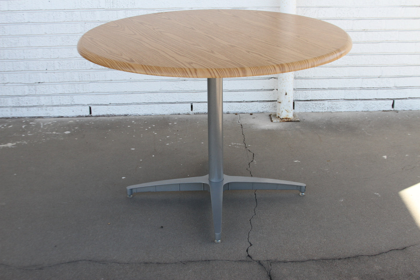 42" Herman Miller Laminate Round Dining Table. Its contemporary design and durable laminate construction create a focal point.