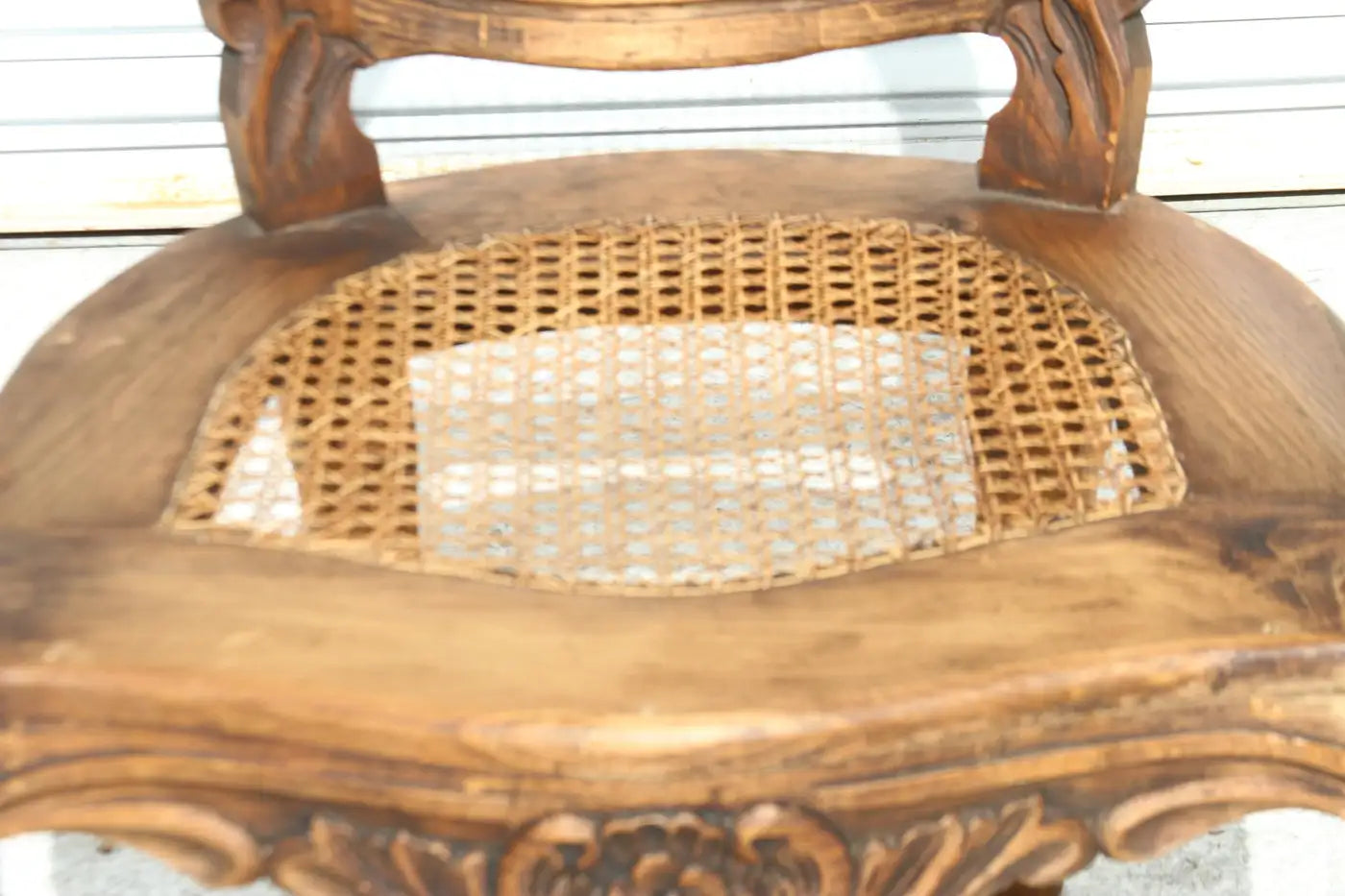 Carved Louis XVI fauteuil with cane seat and back