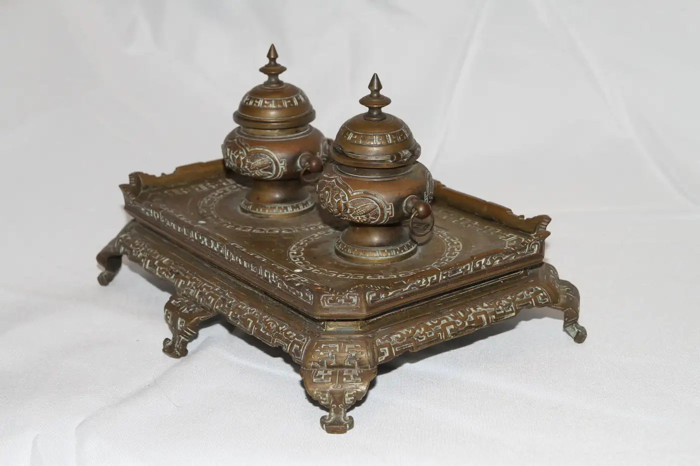 Close-up of antique filigree brass inkwell