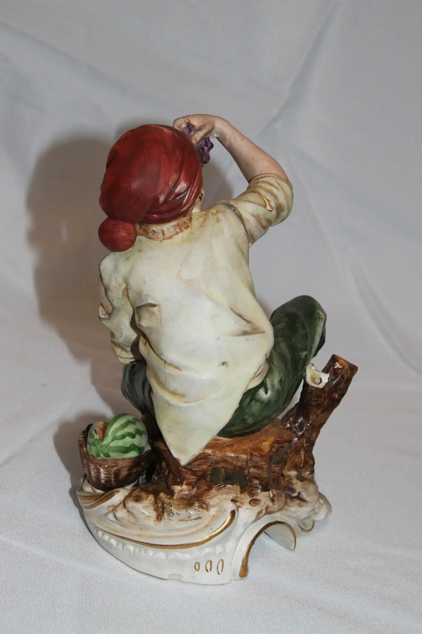 Artistic man eating fruit statue