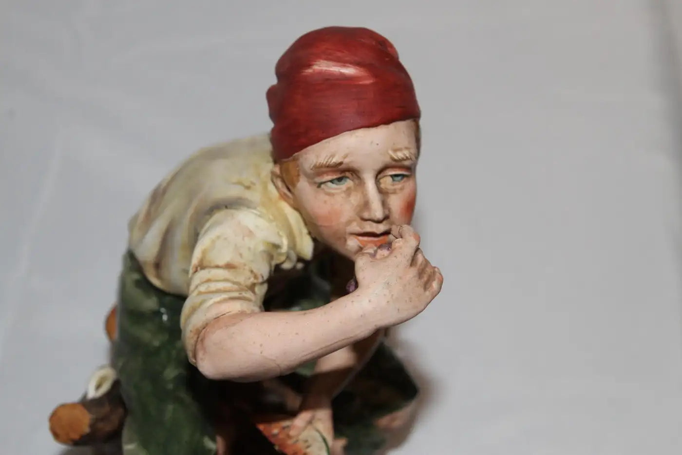 Figurine of man enjoying grapes and watermelon