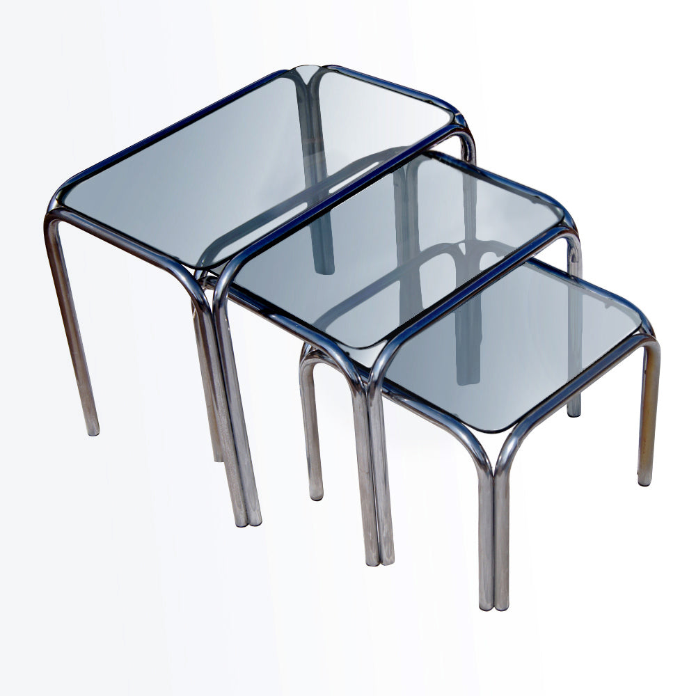 Retro vintage nesting tables featuring chrome frames and smoked glass tops.