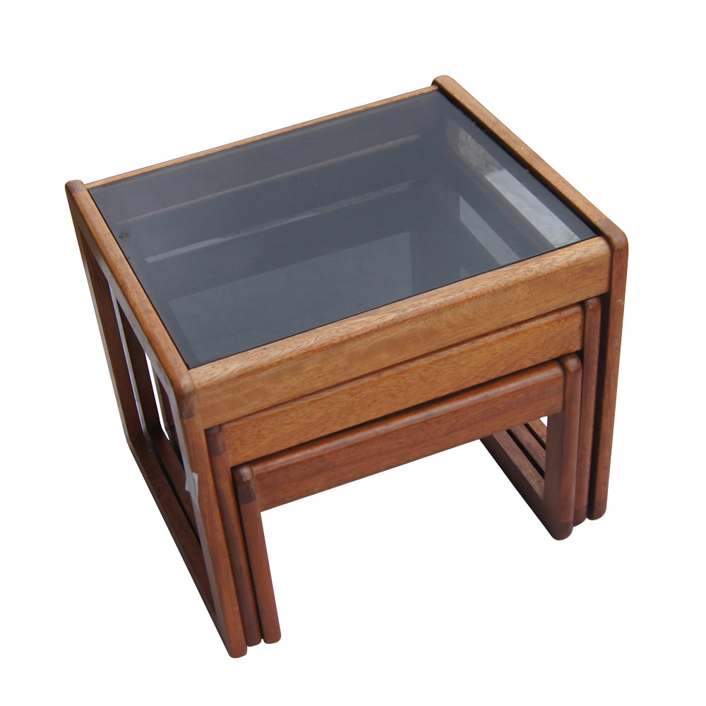 Walnut nesting tables with glass tops in set of three