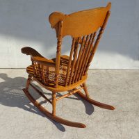 antique style wood rocking chair on hardwood floor