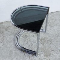 Sleek glass and chrome side tables in nesting design