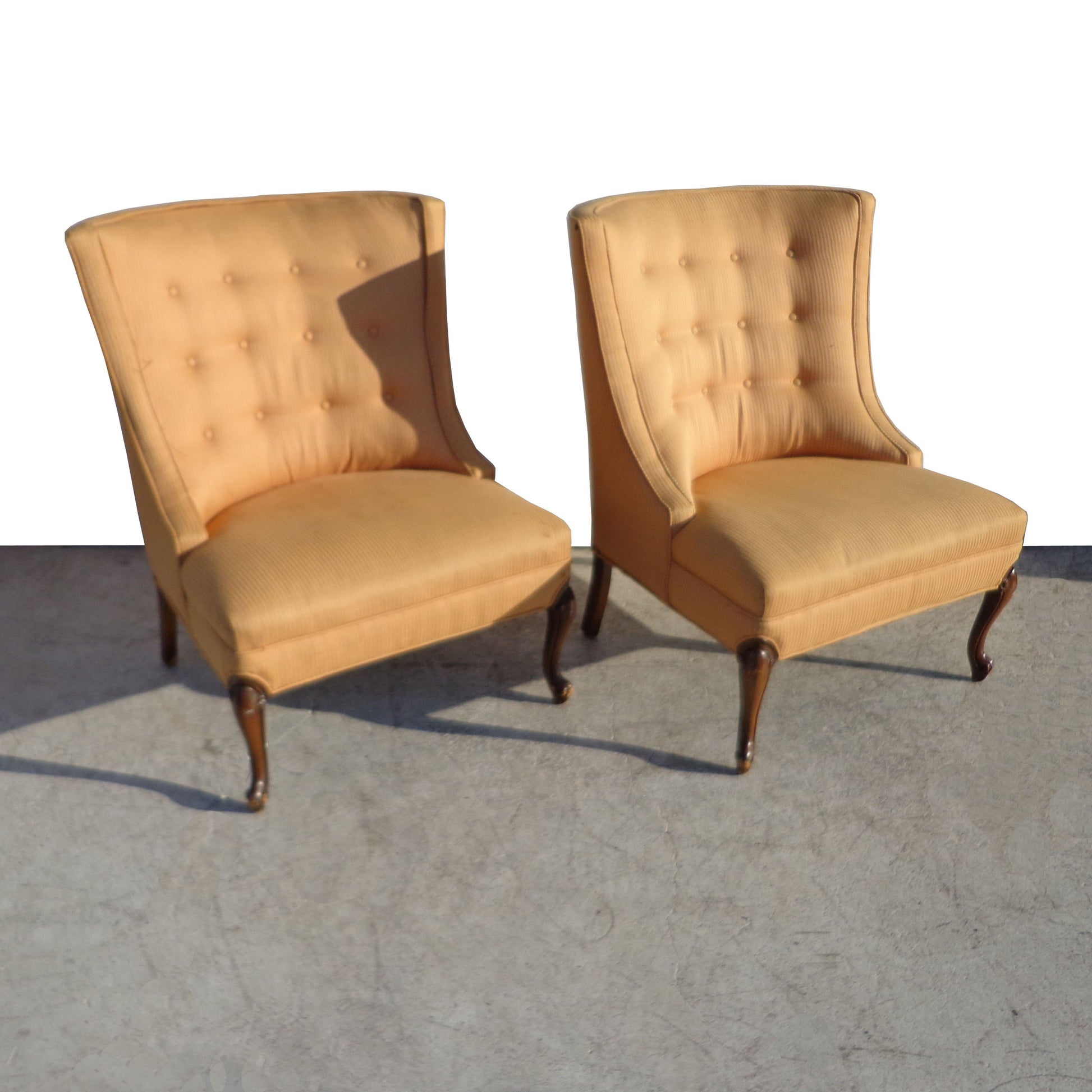 Regency-style Slipper Chairs, showcasing mid-century design elements like button-tufted upholstery and tapered legs. Perfect for adding character to any space while providing comfortable seating.