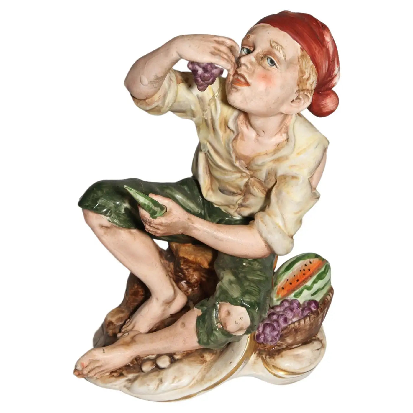 Sculpture of man eating grapes and watermelon