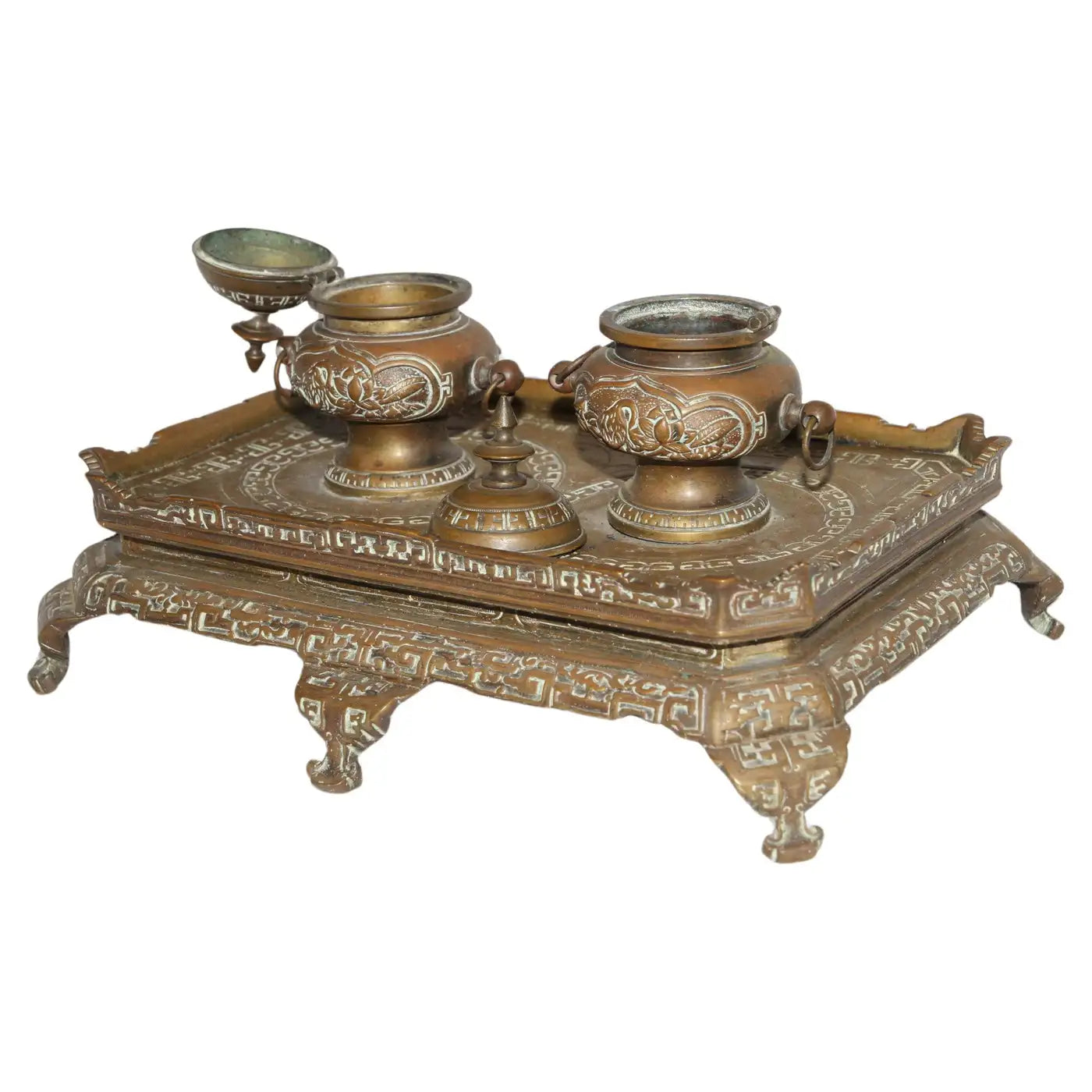 Antique brass filigree double inkwell on wooden desk