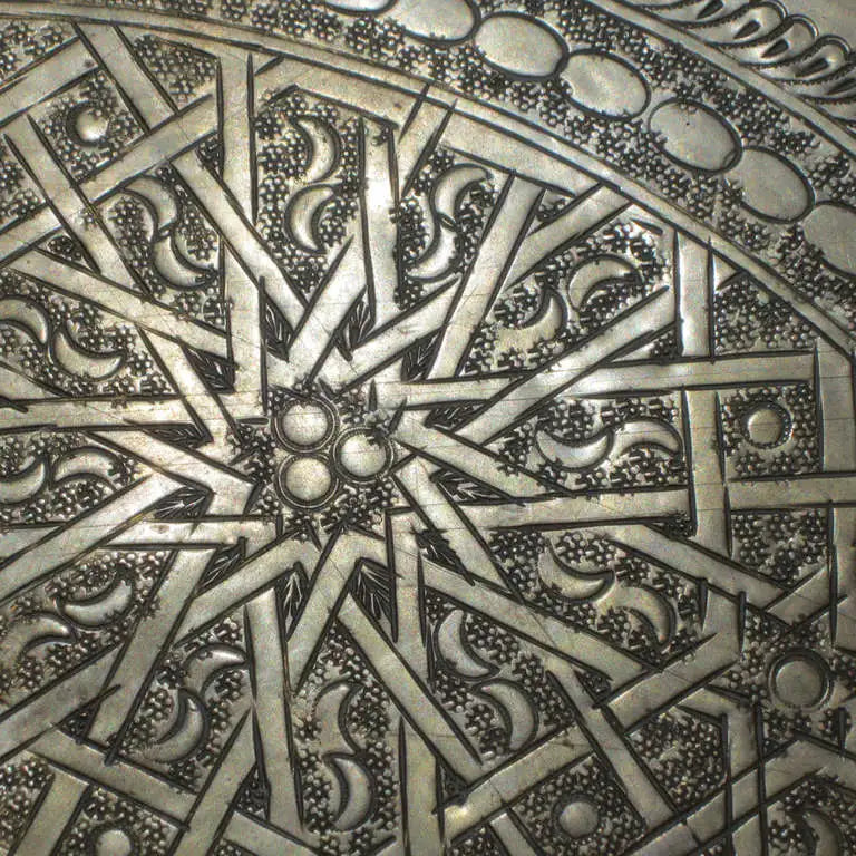 Sculptural bronze furniture piece with detailed peacock design