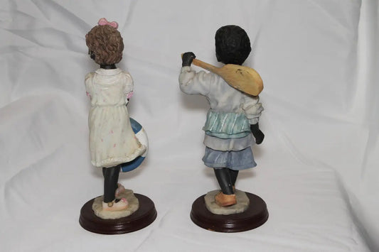 Pair of bisque nodding children figurines