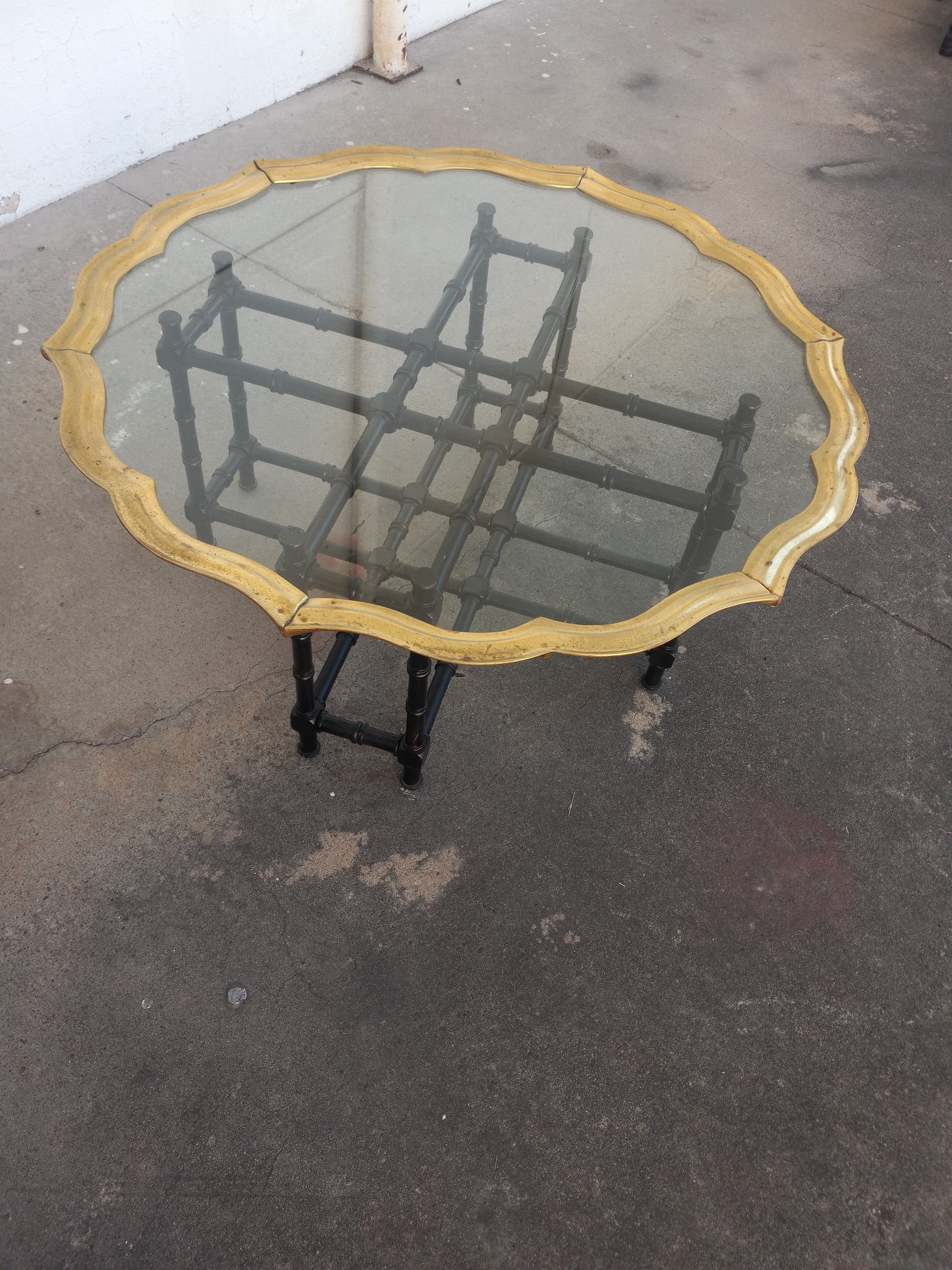 Mid-century glass coffee table with brass accents