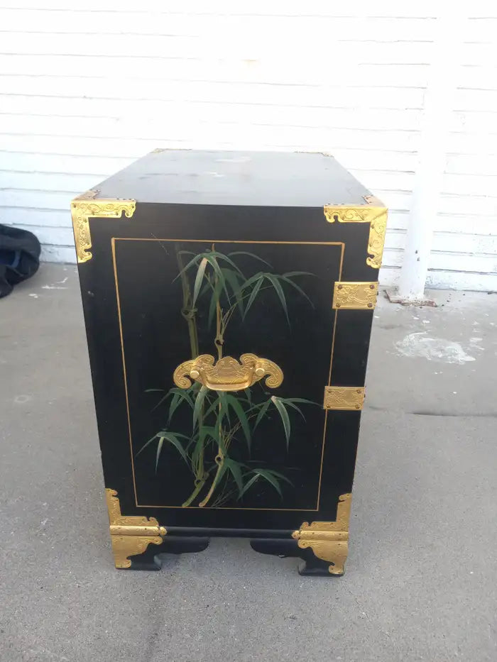 Lacquered Chinese Chinoiserie cabinet with intricate design.