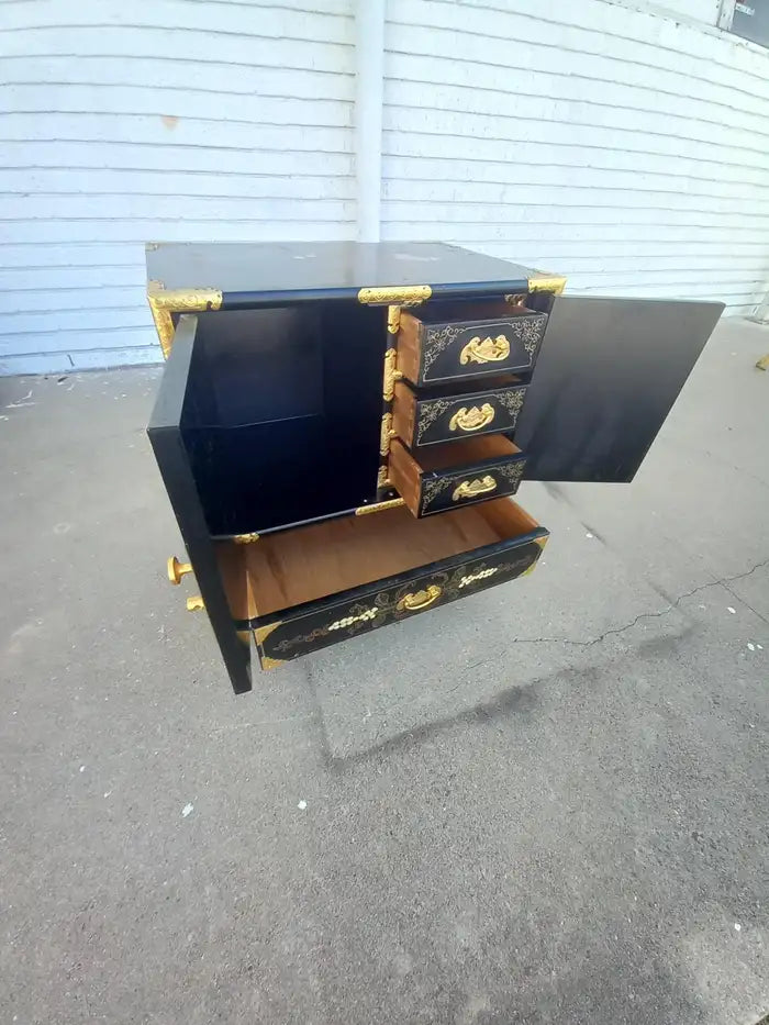 Chinese lacquered cabinet in Chinoiserie style with fine details.