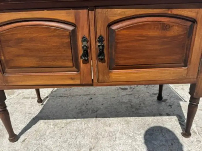 Traditional carved wood cabinet with marble surface