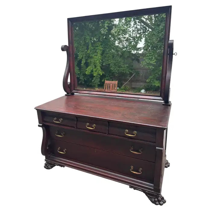 Antique Empire dresser with ornate mirror and wood detailing