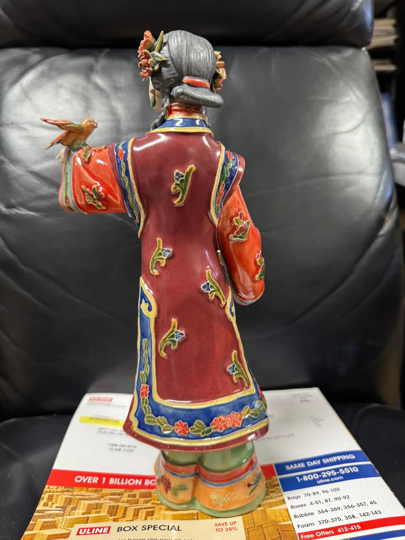 Oriental sculpture figurine with bird and hand-painted accents