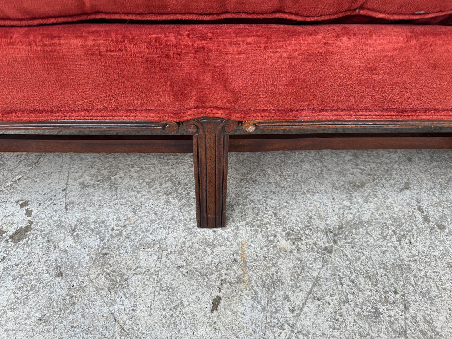 Elegant camelback Chippendale sofa set against an industrial backdrop, full front view.