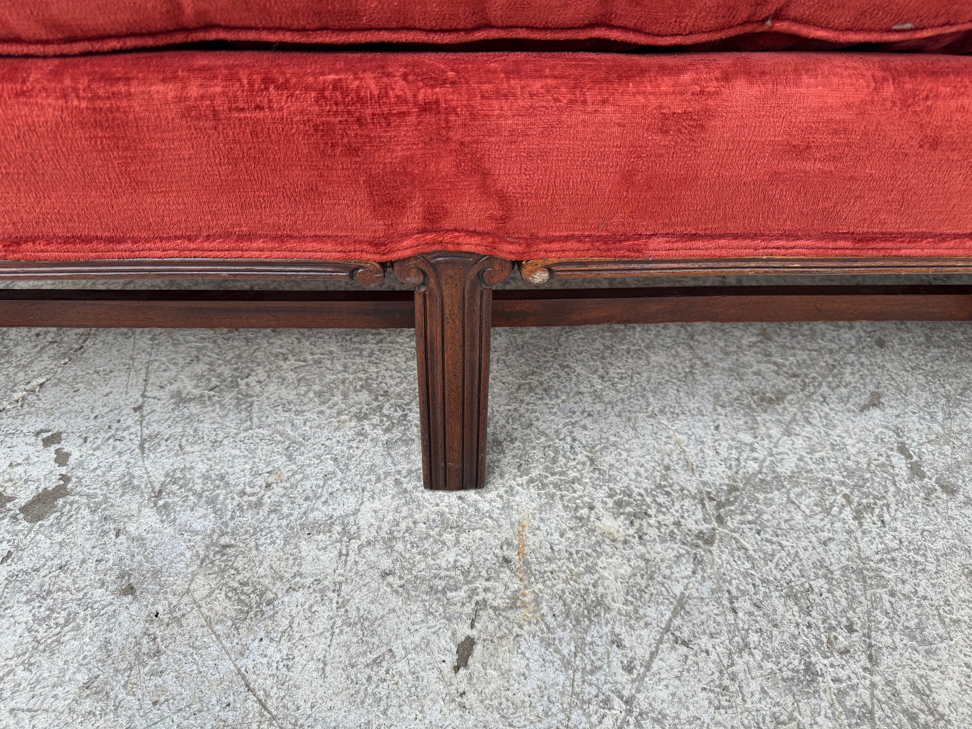 Elegant camelback Chippendale sofa set against an industrial backdrop, full front view.