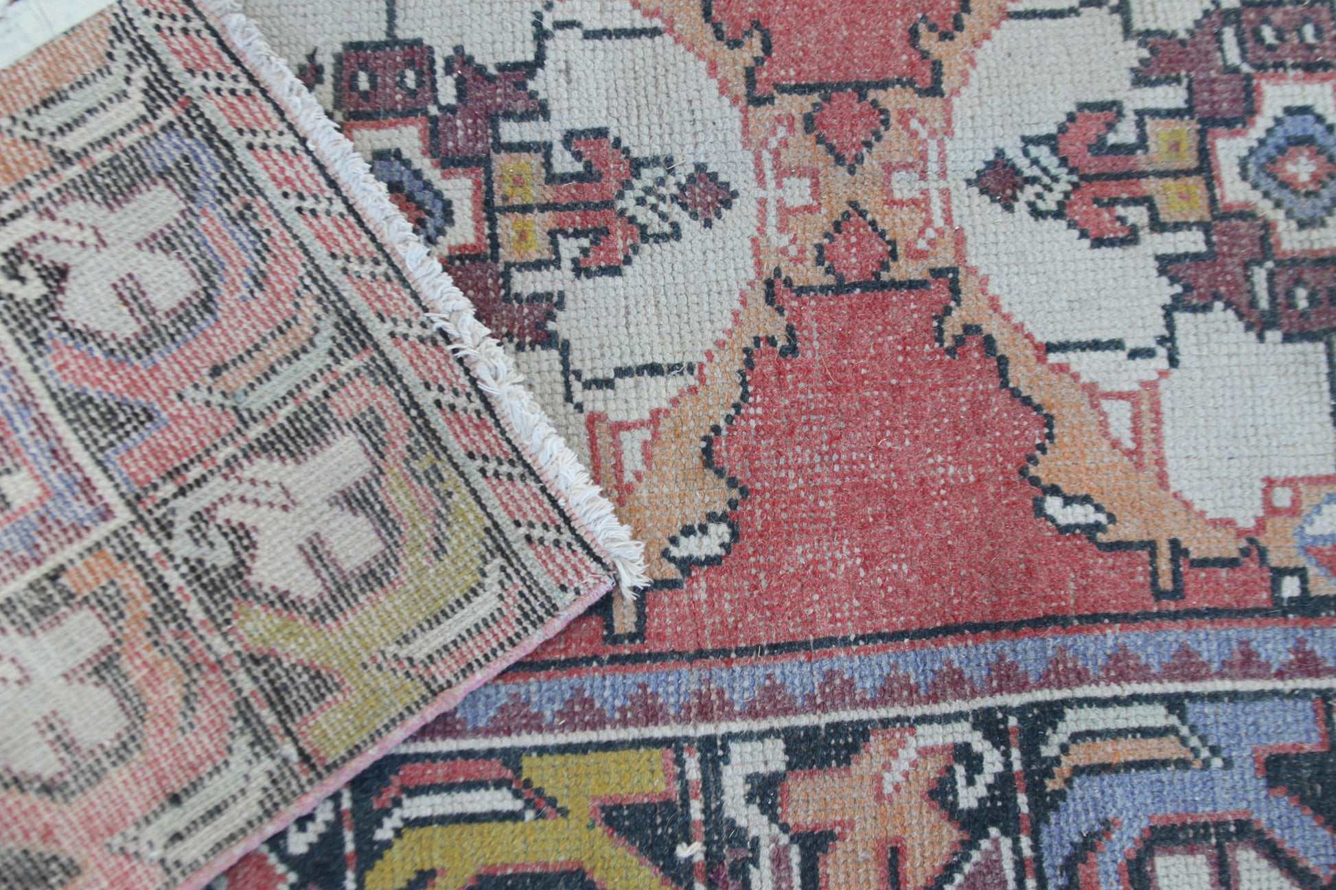 Classic pink runner rug with faded floral details