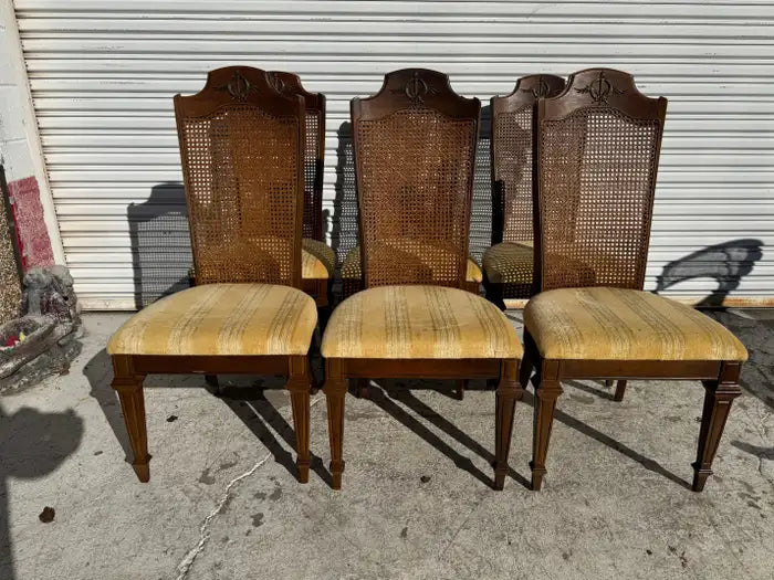Classic walnut dining chairs with woven cane backs