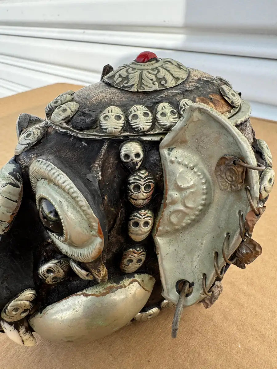 carved wood skull sculpture with aged patina