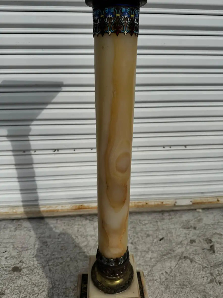 polished onyx pedestal with warm tone marble texture